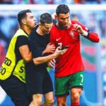 Two fans enter field for selfies with Cristiano Ronaldo during match at Euro 2024